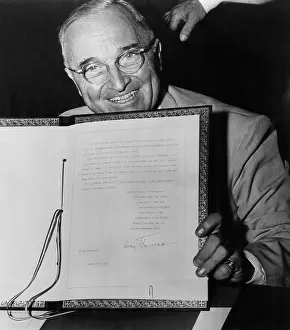 Document Prints: President Truman displays his signature on the ratification of the North Atlantic Treaty