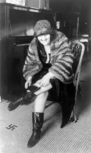 Secret Prints: Prohibition, a woman putting a flask in her Russian boot, Washington DC, 1922