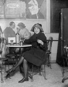 Prohibition Prints: During Prohibition, a young woman fortifies her drink with alcoholic poured from a walking stick in 1922
