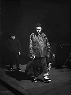 Sidewalk Prints: Prosperous Chinese-American walking in San Franciscos Chinatown followed by his bodyguard
