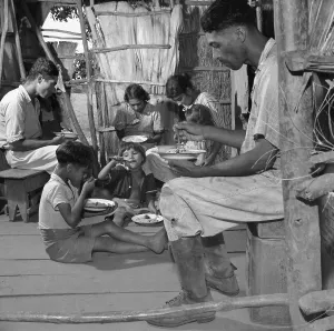 Rice Prints: Puerto Rican family eating their main meal: rice