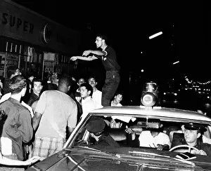 Civil Rights Prints: Puerto Rican youth standing on a police car