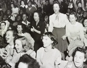 Excitement Prints: Racially integrated audience listens as singer Frank Sinatra speaks against racial prejudice in Gary