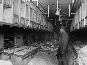 Newspapers Prints: Railway Post Office (RPO) clerks sorting mail aboard a customized rail car in 1924
