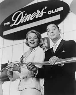 Worlds Fair Prints: Ralph Schneider assists Patti Page cutting ribbon to open Diners Club exhibit at 1964 World's Fair