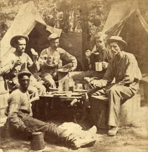 Images Dated 27th January 2009: Relaxed scene of soldiers from the Army of the Potomac eat their meal in the company of an African American