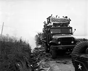 Trucks Prints: Released Communist POWs in trucks ripped off their foreign clothing and threw it away
