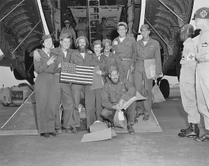 Freed Prints: Released POWs, a B-29 crew pose with their flight nurses at Tachikawa Air Base
