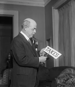 Taxes Prints: Republican Congressman Nicholas Longworth (1869-1931) 'cutting taxes' for the press photographers