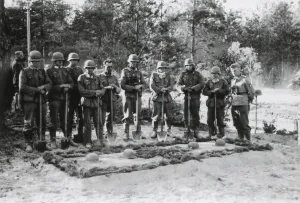 Lcgr1406 Prints: Reverent German soldiers stand with shovels at the grave of the commanding officer