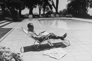 Swimming Pool Prints: Richard Nixon reading newspapers while sitting by the pool in San Clemente. Ca. 1969-74