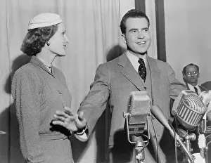 Microphones Prints: Richard Nixon standing behind microphones with wife Pat shortly after the 1952 election