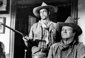 Shotgun Prints: RIO LOBO, George Plimpton, John Wayne, 1970.. Courtesy: CSU Archives / Everett Collection