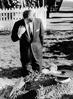 Robert Kennedy prays at his brother's grave. On the first anniversary of the John Kennedy assassination, the new Senator-elect attended a Memorial Mass at St