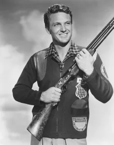 2 Mej Prints: Robert Stack with skeet shooting championship patch on his jacket, 1948