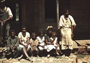 Shoeless Prints: A rural African American family seated on the porch of their house on a house Bayou Bourbeau plantation