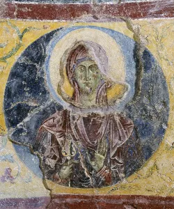 Saint Scholastica, by Unknown Artist, 5th - 11th Century, fresco - Italy, Lazio, Montecassino, Abbey. Whole artwork view. Round frame with the head of the holy woman