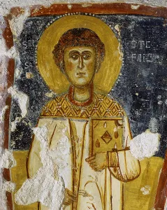 Saint Stephan, by Unknown Artist, 11th Century ca. fresco - Italy, Puglia, Mottola, Rocky Church of Saint Margaret. Detail. The holy man holding a book in his hand