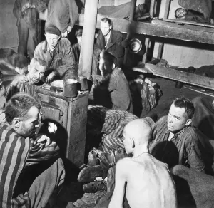 Russians Prints: Sandbostel Prison camp survivors sit around a stove fire after British Liberation