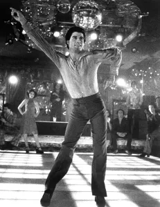 Drescher Prints: SATURDAY NIGHT FEVER, Fran Drescher (background left), John Travolta, 1977