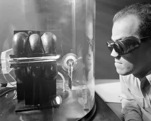 Rocket Science Prints: Scientist with protective glasses and nose cover experimenting with Ion Jet rocket propulsion