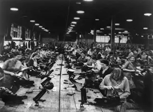 Laborer Prints: Scores of British women perform light bench work at a small arms factory