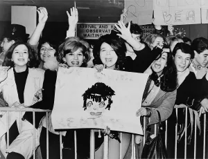 Beatles Prints: Screaming teenagers girls wave a crude sign as they welcome The Beatles at New York's Kennedy Airport