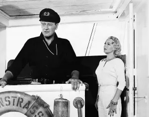 Shipboard Prints: THE SEA CHASE, from left, John Wayne, Lana Turner, 1955