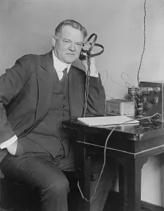 Radios Prints: Sec. of Commerce Herbert Hoover (1874-1964) listening to radio with headphones in 1925