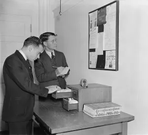 Study Prints: Secret Service agents checking over bulletin board getting the latest criminal news