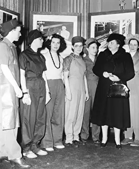 Secretary of Labor Frances Perkins examines work clothes for women. March 1, 1943. The work clothes for women were designed to promote safety and efficiency