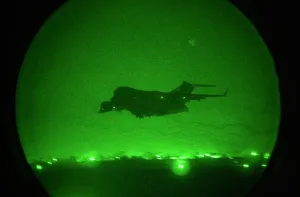 Images Dated 16th March 2011: Seen in the green glow of a night scope a C-17 Globemaster military transport takes-off with lights out from an air