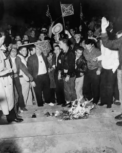 Disorder Prints: Segregationist protest. White students burn integration literature to protest the enrollment of an African American