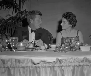 Tuxedos Prints: Senator John Kennedy in conversation with Lady Bird Johnson at a Democratic $100 Dinner at Sheraton Park Hotel