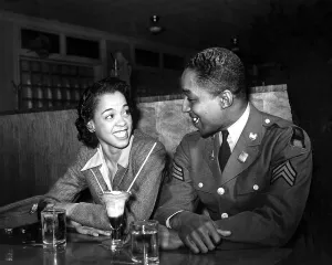 Sgt. Franklin Williams, on leave from army duty, with his best girl Ellen Hardin, splitting a soda. May 1942, during World War 2. (BSLOC_2013_14_251)