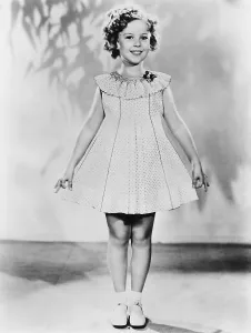 1930s Fashion Prints: Shirley Temple, modeling a dotted-Swiss dress, ca. 1936
