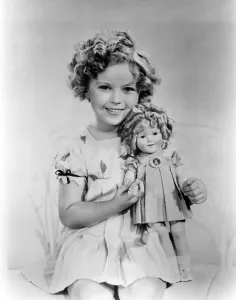 Temple Prints: Shirley Temple with a Shirley Temple doll, ca. 1936