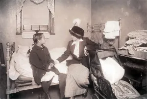 Sitting On Bed Prints: Sick child in New York City, from original caption: Investigator talking with Ida List