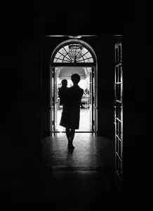 Families Prints: Silhouette portrait of Jacqueline Kennedy carrying her one year old son John Kennedy Jr