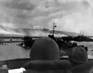 English Channel Prints: Silhouetted by helmets, view shows two landing craft at Omaha beach on D-Day