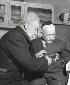 War 2 Prints: Simon Trampatter, a 83-year-old Dutch Jew cuts the star off the coat of his friend