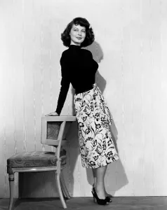 SINGAPORE, Ava Gardner, in a black jersey top, black-and-white skirt and leather belt, 1947