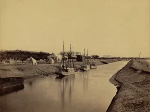 Waterways Prints: Small boats moored at water's edge to the Suez Canal at Ismailia