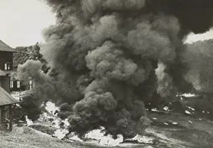 Colonies Prints: Smoke rises from a rubber factory destroyed by the retreating British forces in Malaya