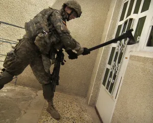Iraq Prints: US soldier breaks down a door during a house-to-house search for illegal weapons