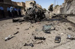 June Prints: US soldier inspects the area around a suicide bomber's vehicle in Tuz Iraq