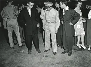 Armed Prints: Soldier inspects Zoot Suiters at an intermission of Woody Herman's Orchestra engagement