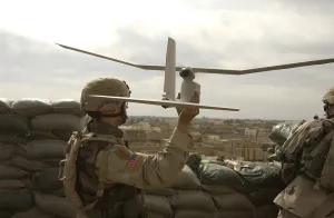 Electronics Prints: US soldier launches a Raven unmanned aerial vehicle to conduct reconnaissance of insurgents attacking Patrol Base