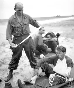 Bandages Prints: Soldiers aided by corpsmen after their tank hit a land mine during the Philippine invasion