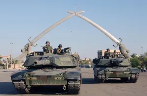 Iraq Prints: Soldiers in an Army Abrams Tank pose for a photo under the Hands of Victory in Ceremony Square Baghdad Iraq
